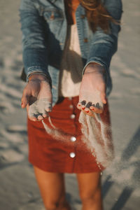 Low section of man standing on beach