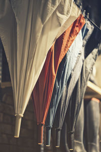 Close-up of umbrellas hanging in row