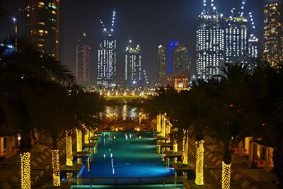 Illuminated modern buildings in city at night