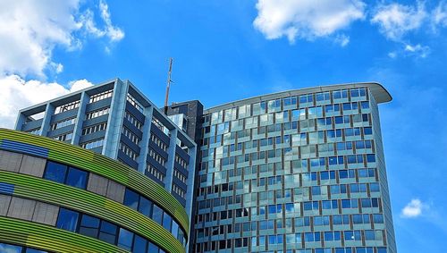 Low angle view of modern building against blue sky