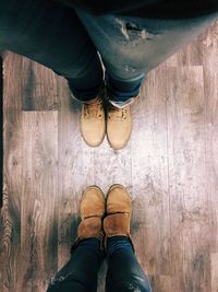 Low section of person standing on tiled floor