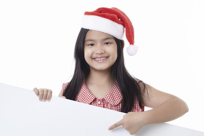 Portrait of a smiling young woman against white background