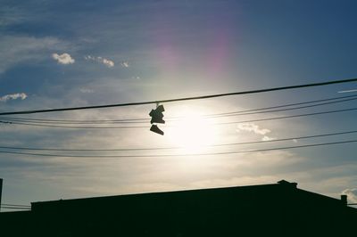 Low angle view of power lines against sky