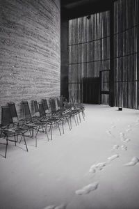 Empty chairs and tables in building