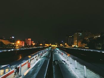 Illuminated bridge against sky at night