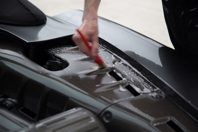 Close-up of hands working in water