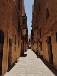 Alley amidst buildings against sky