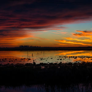 Scenic view of sea against romantic sky at sunset