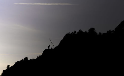 Low angle view of silhouette trees against sky at sunset