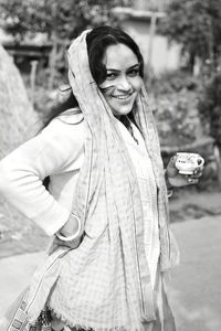 Portrait of smiling woman standing outdoors