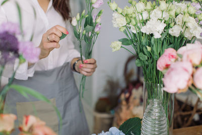 Midsection of florist making flower bouquet