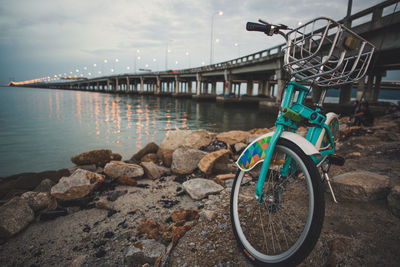 Bicycle on beach against sky