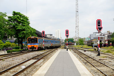 Train at railroad station against sky