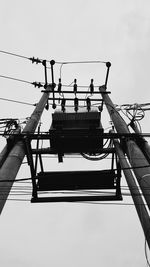 Low angle view of power lines against clear sky