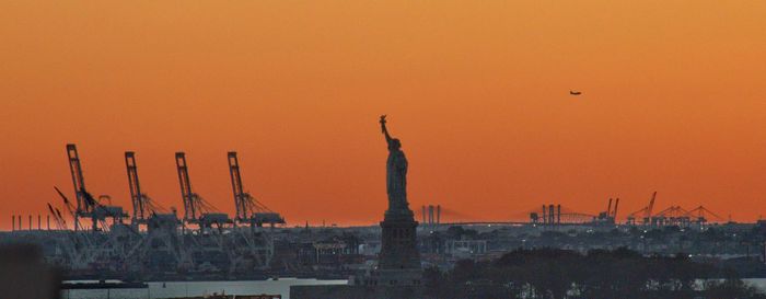Silhouette of building against sky during sunset