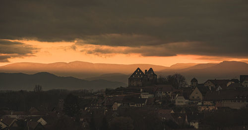 Townscape against sky during sunset