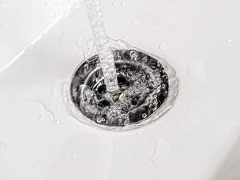 High angle view of water splashing in container