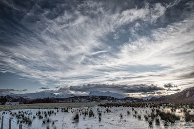 Scenic view of lake against sky during winter