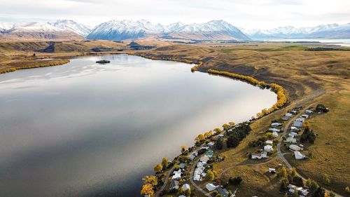 Scenic view of calm lake and mountains against sky