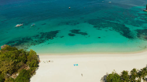 Tropical white sand beach in a lagoon with turquoise water on boracay island, philippines