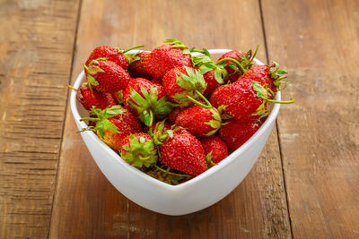 High angle view of strawberries in bowl on table