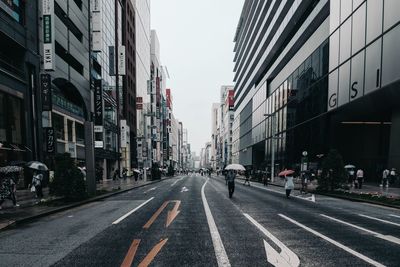 City street and buildings against sky