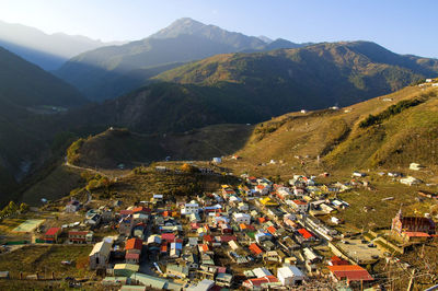 High angle view of houses and mountains against sky