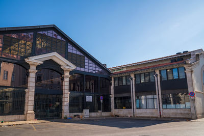 Low angle view of building against clear blue sky