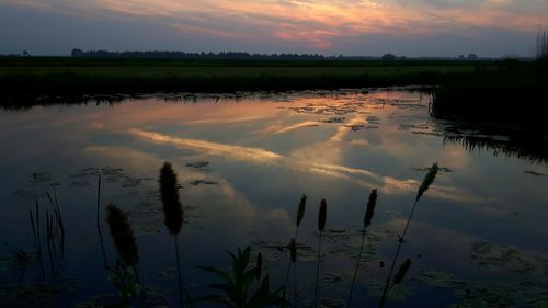 Scenic view of lake against sky during sunset