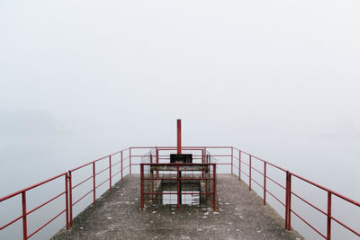 Steps leading towards sea against clear sky during winter