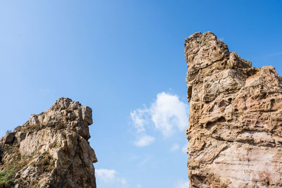 Low angle view of rock formation against sky