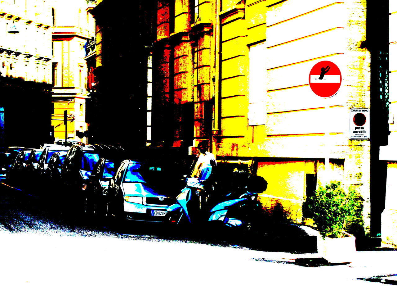 ROAD SIGN ON STREET AGAINST BUILDINGS