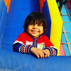 Close-up of cute smiling boy standing in bouncy castle