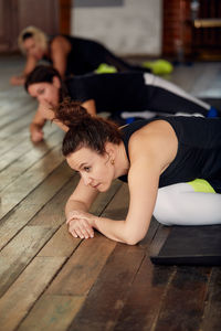 Females exercising at yoga studio