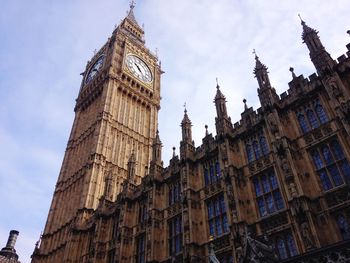 Low angle view of clock tower against sky