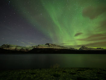 Scenic view of landscape against sky at night