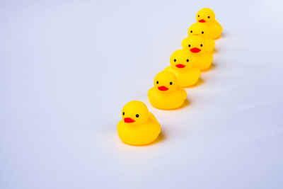 Close-up of yellow toy over white background
