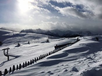 Scenic view of landscape against sky during winter