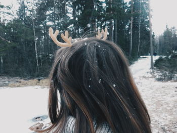 Close-up of girl wearing costume on snow covered field