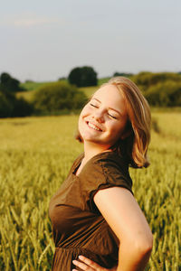 Portrait of a smiling young woman in field