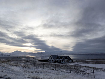 Scenic view of snow covered land against sky during sunset