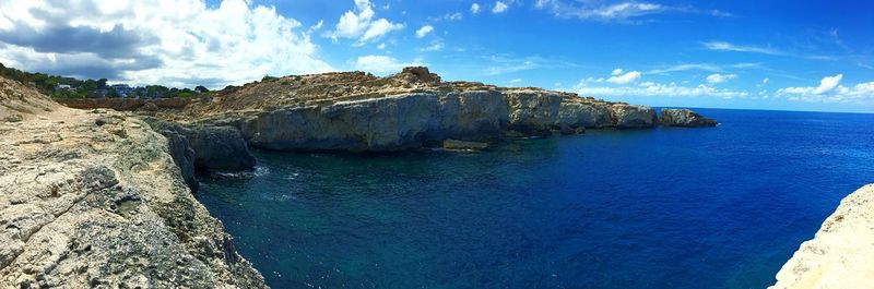 Panoramic view of sea and rocks against sky