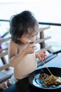 Cute girl eating food on table