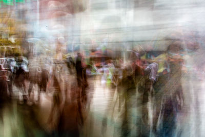 Blurred motion of people walking on street