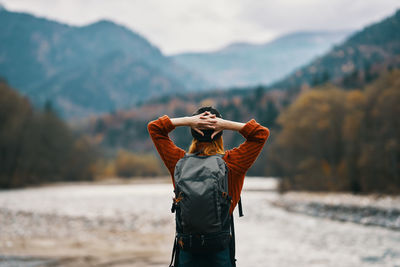 Rear view of man standing in water