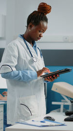 Doctor using digital tablet in clinic