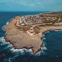 High angle view of sea and buildings against sky