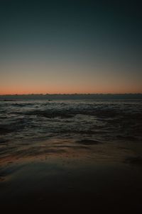 Scenic view of sea against clear sky during sunset