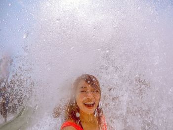 Portrait of a smiling young woman in water