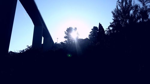 Low angle view of silhouette trees against clear sky